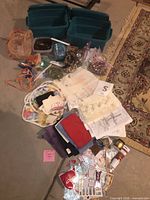 Overview of all craft supplies with bins, fabrics, stones, paint and tools laid out