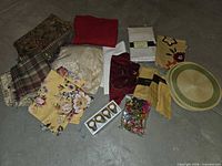 Grouped linens, placemats, napkin rings, wine charms