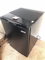 Full view of black Kenmore mini refrigerator