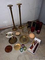 all items laid out showing candlesticks, candles, trays, votive holders