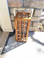 Lantern standing upright showing wood grid and metal handle