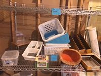 Overview of assorted baskets, magazine files, wicker basket, trays on shelving