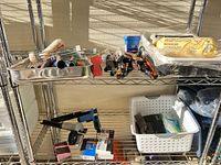 Shelving with metal tray of brushes, scrapers, roller covers, sandpaper blocks, Velcro packs and bagged drop cloths