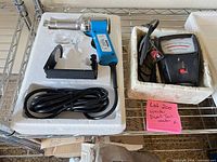 Both styrofoam trays showing Remtech tool, power cord, bracket, and separate analog dwell/tach meter