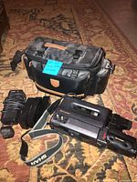 Full lot showing camcorder, three batteries, charger, bag