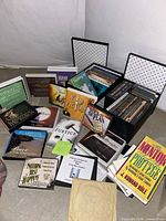 Group shot of all discs, VHS tapes, book and storage case