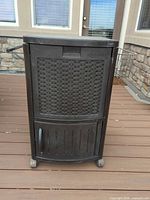 Front view of brown resin wicker Suncast patio cooler on wheels