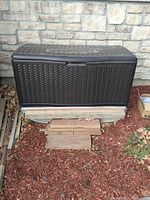 Front view of Suncast resin wicker deck box