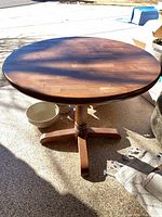 Top view of round wood pedestal table showing surface and finish