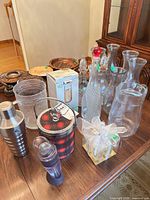 Group shot showing wine aerator, shaker, ice bucket, decanters, carafes, boxed flutes and shot glasses