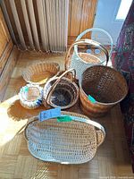 Group shot of six assorted wicker baskets on floor
