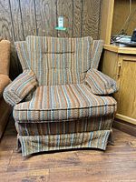 front view of striped upholstered armchair