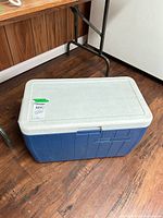 Top angled view of blue Coleman chest cooler showing lid and body
