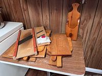 Overall lot showing stacked cutting boards, mandoline slicers, hand guard