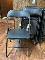 Front view of single black folding chair