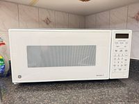 Front view of GE Spacemaker II microwave on countertop showing full unit