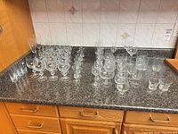 assorted clear glasses on countertop, full lot view