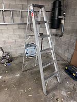 Full side view of the aluminum step ladder set up in A-frame position