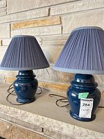 Both table lamps side by side on mantel showing overall appearance with shades