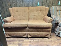 Front view showing full loveseat, fabric, cushions and skirt