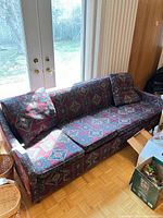 Front view of sofa bed showing patterned upholstery and cushions