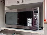 Front view of microwave showing door, control panel and overall condition