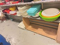 Shelf with various plastic containers and bowls including the items in lot