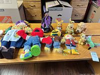 Overview of all plush dolls and plastic figurines on tabletop
