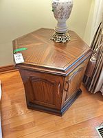 Full view of hexagonal wood veneer side table with doors closed