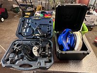 Spin saw set opened next to box containing blue polisher