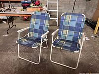 Front angled view of both folding lawn chairs