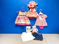 All clothing items, plush, book displayed