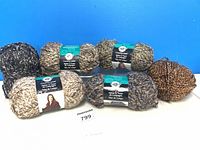 All six yarn skeins arranged on table showing labels and colours