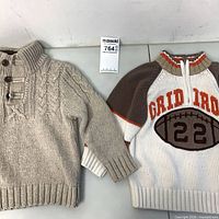 Both sweaters front view