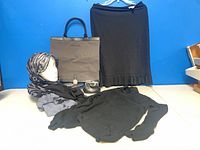 Overview of tote, skirt, turtleneck, scarf, coin purse and cosmetics
