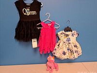 Three dresses on hangers and cat plush