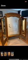 Front view showing three mirror panels and wood frame