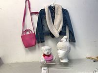 Full lot overview: bag, denim jacket, scarf, toque on mannequin head, teddy bear plush