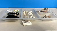Full view of glass tray holding assorted jewelry