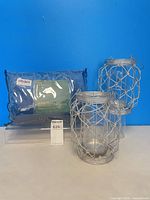 Packaged navy blue curtains with hurricane lanterns group shot