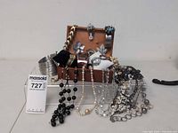 Assorted costume jewelry displayed with chest