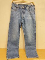 Front view of Levi’s 501 jeans hanging