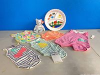 All items overview: five clothing pieces, plate, Ty bear