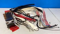 Pile of assorted new belts in various colors and styles