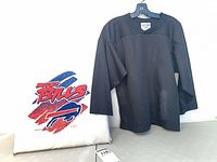 Black jersey on hanger and Buffalo Bills seat cushion