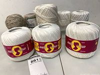 Three South Maid balls, two unlabeled white balls, one ecru ball