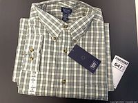 Folded Denver Hayes plaid shirt with tag showing size large