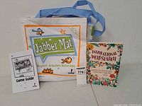 Front view showing Jabber Mat carry bag, instruction booklet, Inspirational Wordsearch book