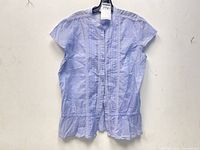 Front view of violet cotton top showing pintuck design and ruffled hem