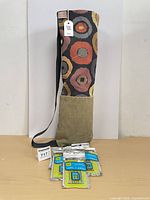 Yoga mat bag standing with five packs hair elastics in front